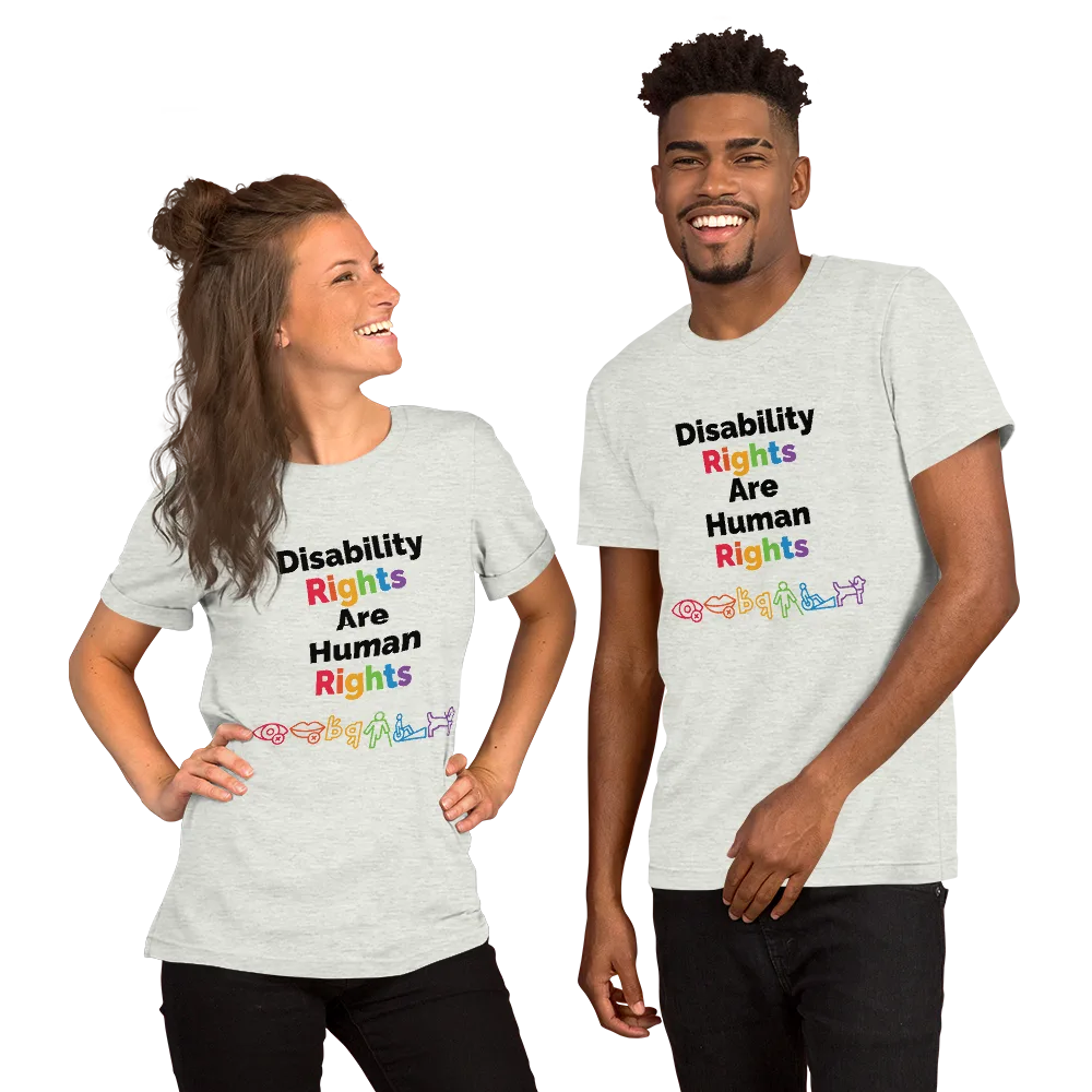 A white woman with long brown hair and a black man with short hair smile posing wearing a shirt from the A11yShop that reads Disability Rights are Human Rights with a rainbow of icons representing different disabilities.